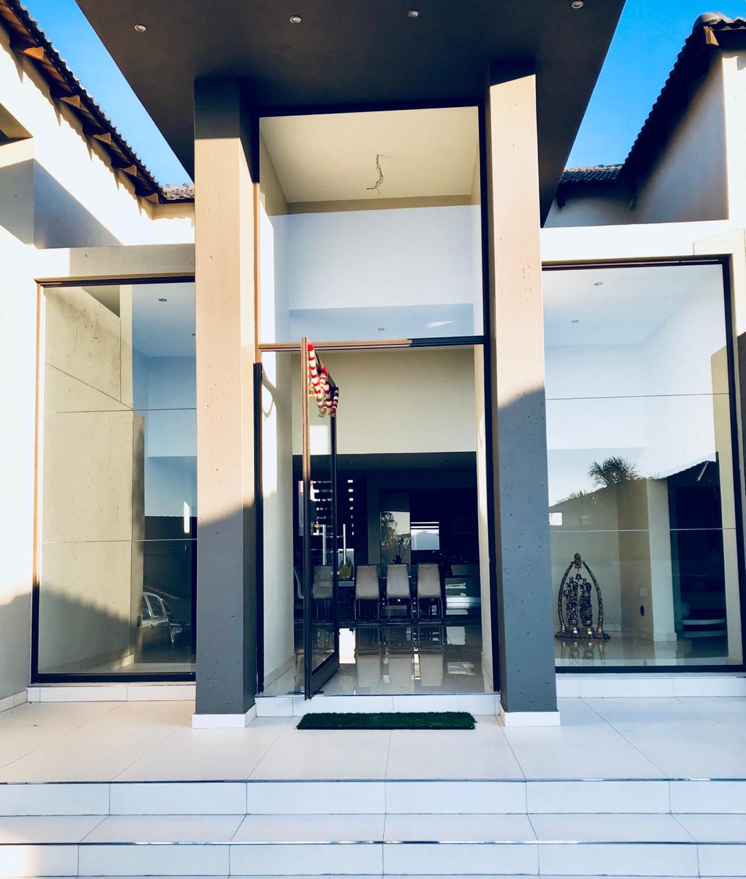 Residential pivot entrance door with full-height glazing